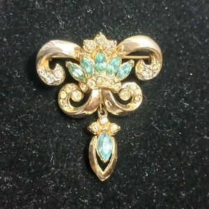 The CORO ? Fleur De Lis Blue & White Rhinestone Brooch Pin